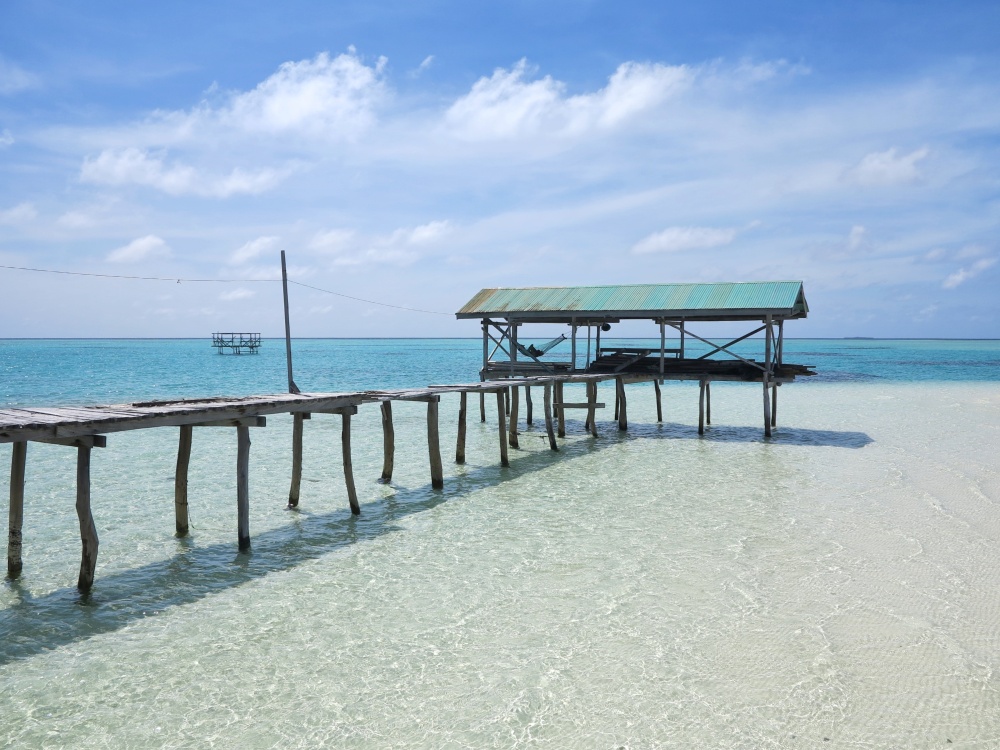 The clear waters and fine, white sand of Onok compliment the wooden structures built in it.