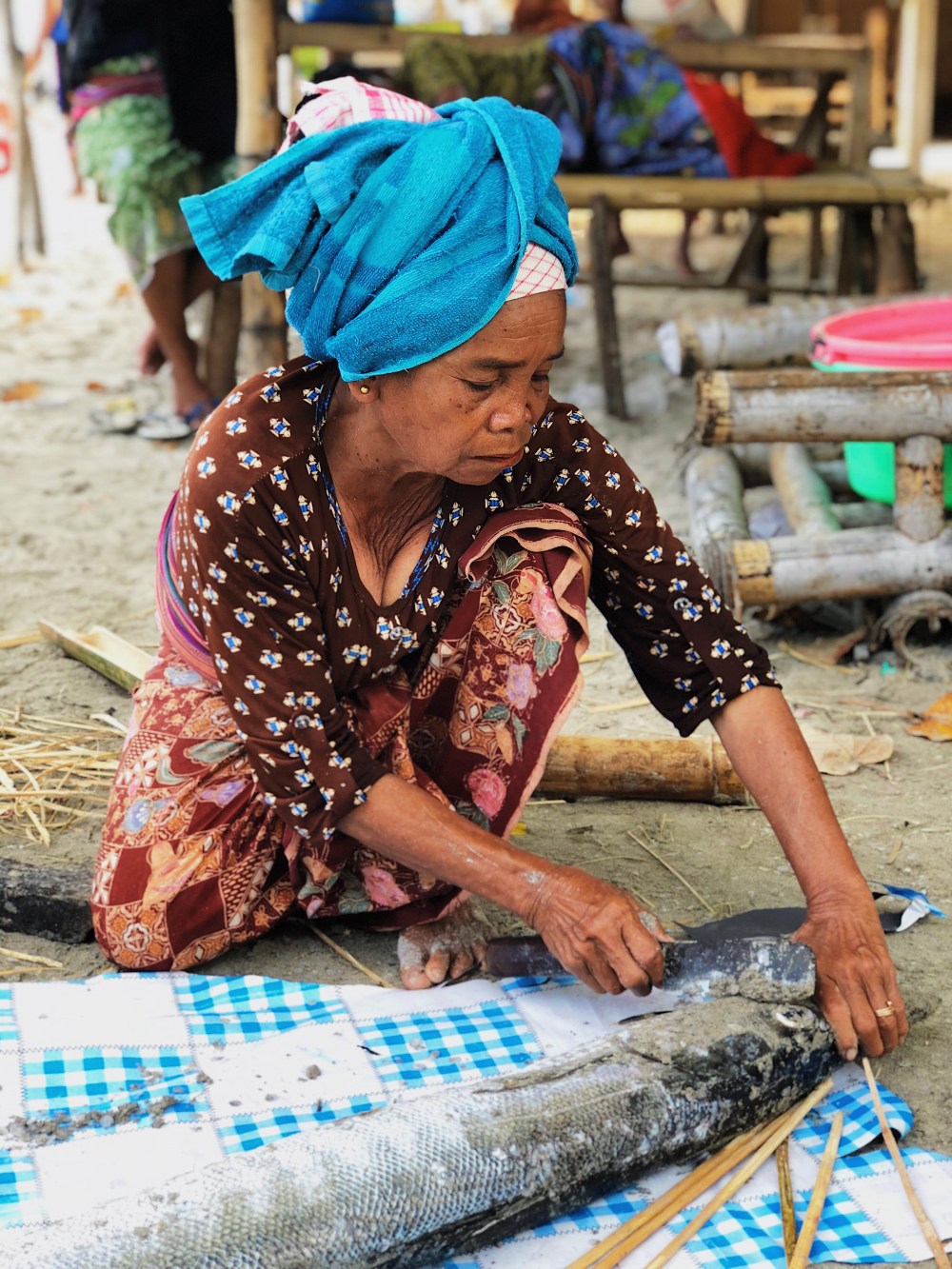 PREPARING THE FRESHLY CAUGHT FISH.
